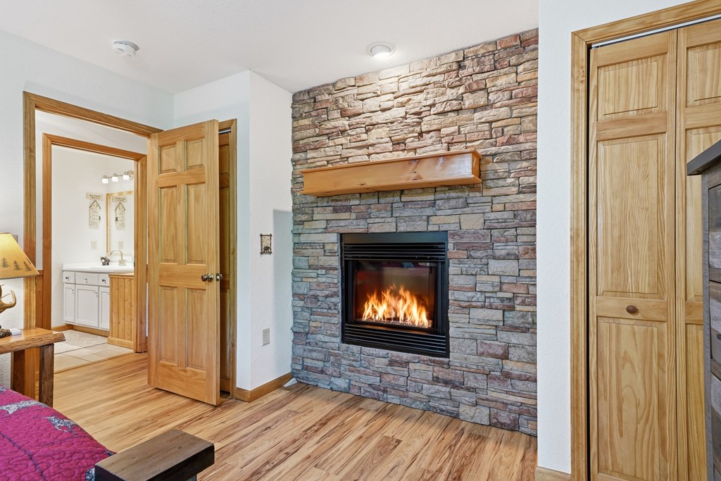 445 Tranquil Cove Road Murphy, NC 28906 - Photo 53 of 91 a view of an empty room with wooden floor and a fireplace