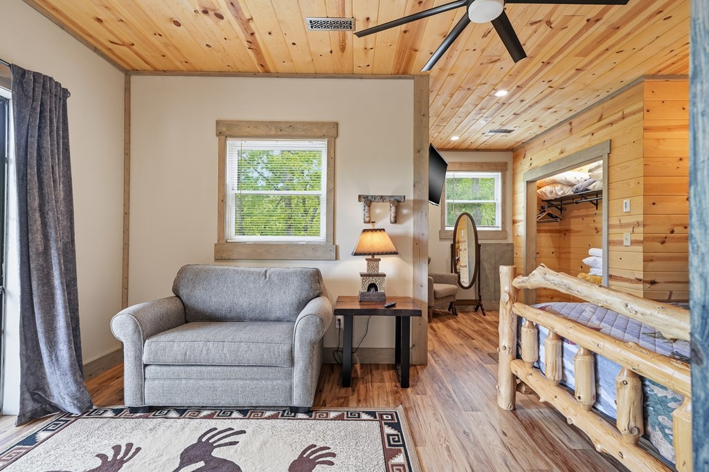 445 Tranquil Cove Road Murphy, NC 28906 - Photo 60 of 91 a living room with furniture a wooden floor and a window