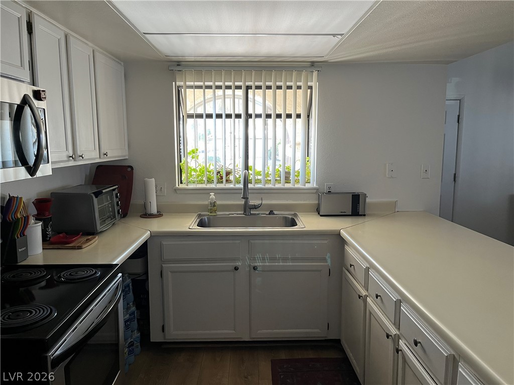 6412 West Pearcrest Road Las Vegas, NV 89108 - Photo 11 of 17 A well-appointed cooking space offers abundant cabinetry and solid surface counters for culinary endeavors.