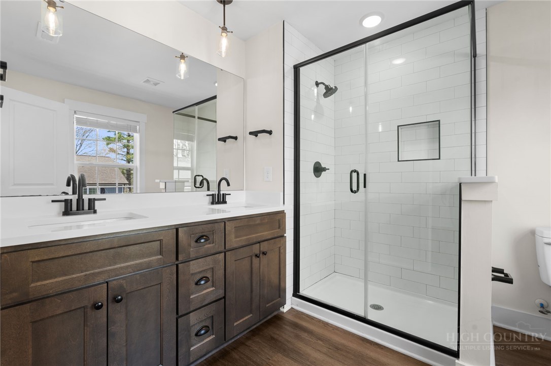 228 Stratford Lane Boone, NC 28607 - Photo 20 of 33 a bathroom with a shower sink vanity and mirror