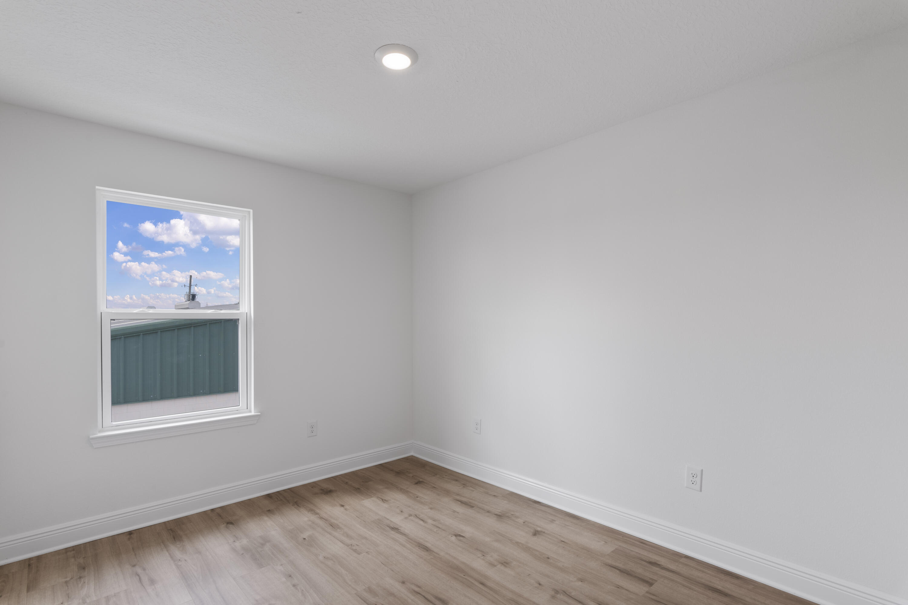 30 Redbird Loop Destin, FL 32541 - Photo 20 of 23 a view of an empty room with wooden floor and a window