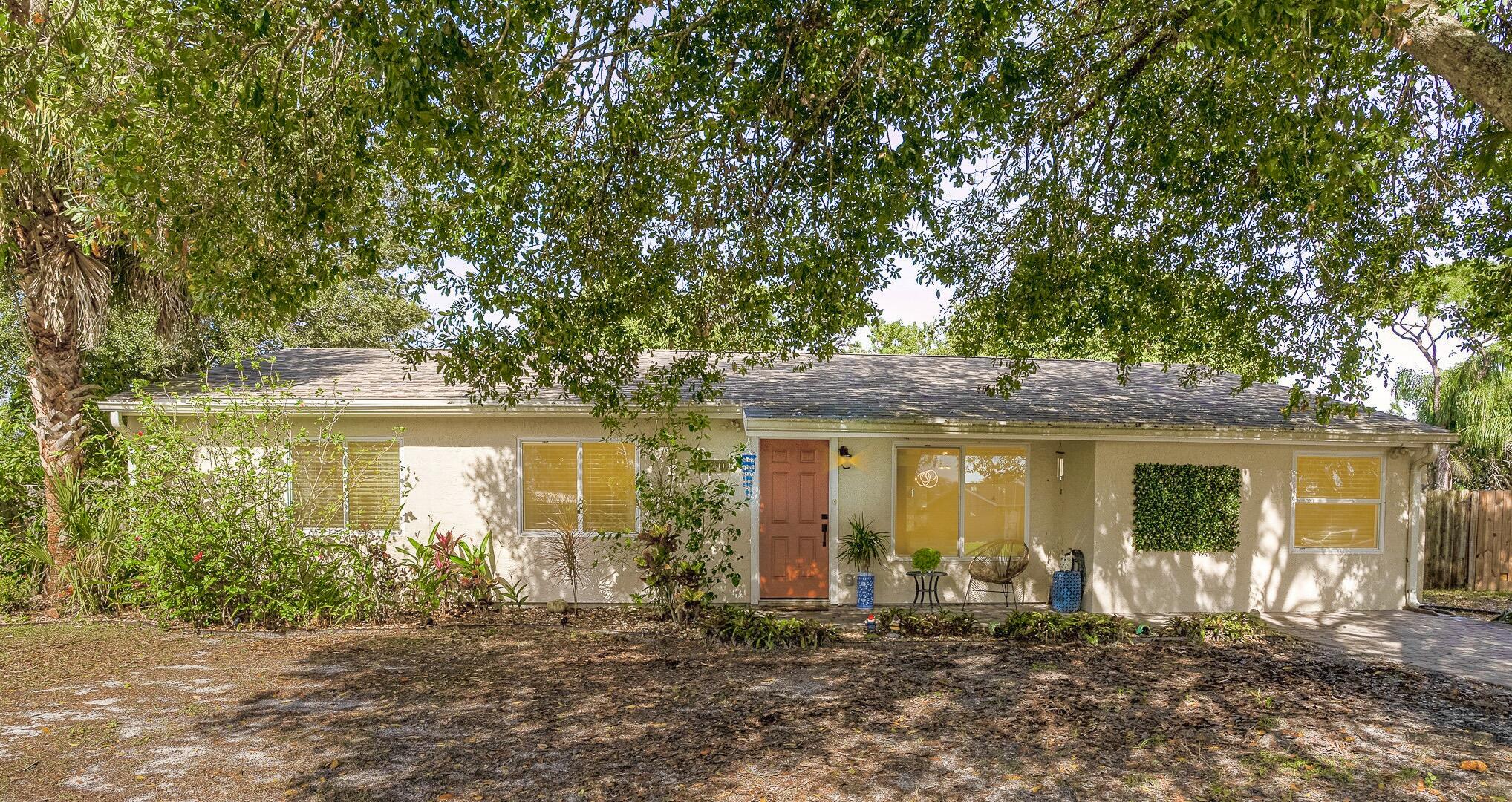 1420 Creel Road Northeast Palm Bay, FL 32905 - Photo 1 of 27 a front view of a house with a yard