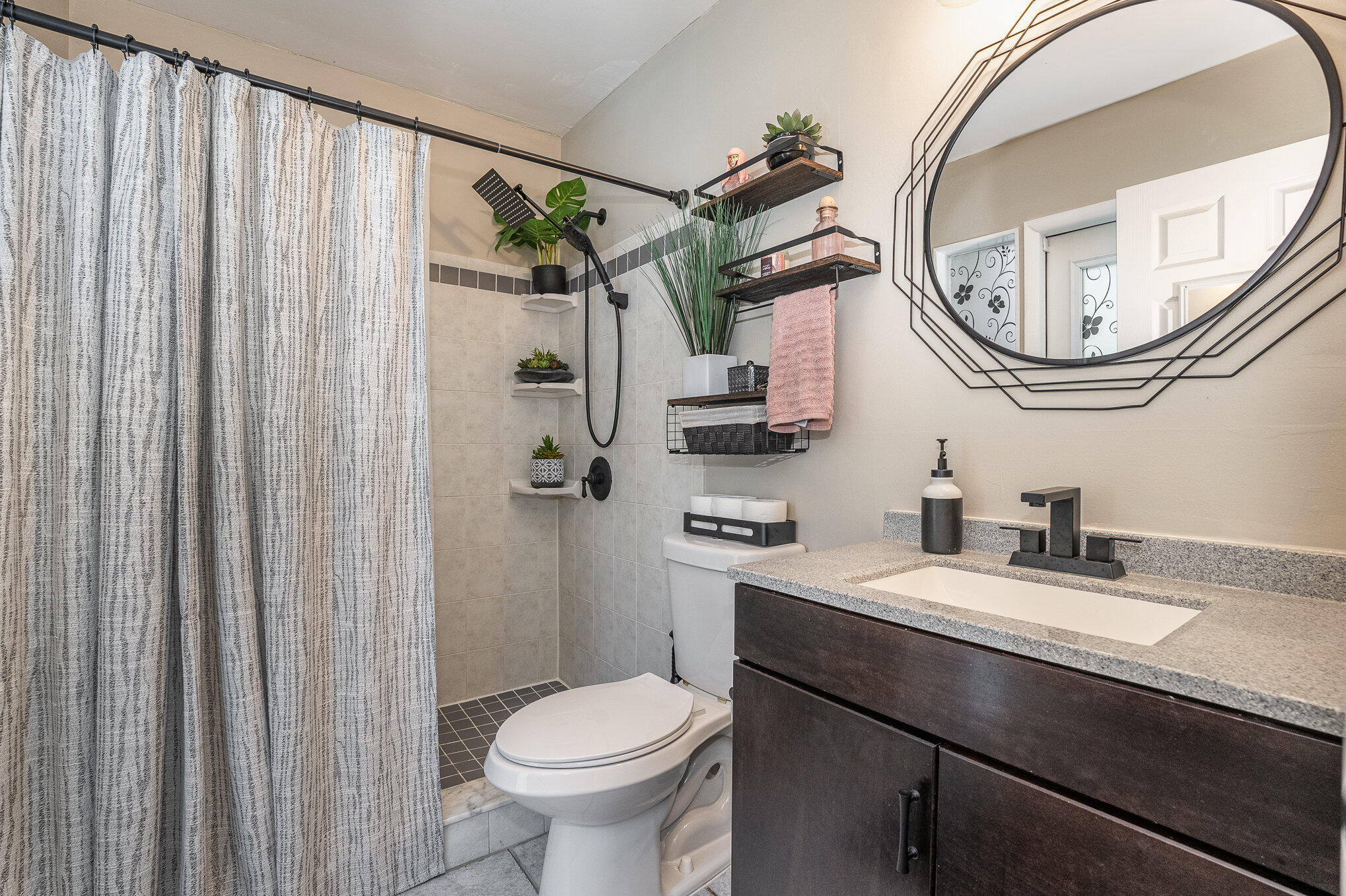 1420 Creel Road Northeast Palm Bay, FL 32905 - Photo 12 of 27 a bathroom with a sink a toilet and a mirror