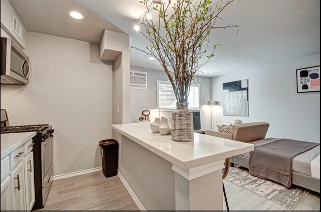 a living room with a couch and a chandelier