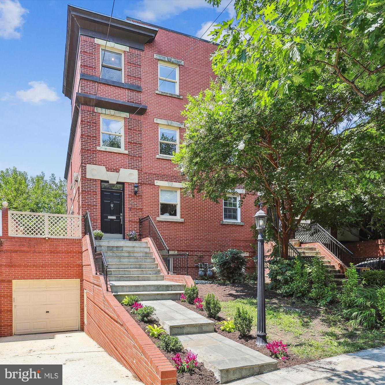 1406 Foxhall Road Northwest Washington, DC 20007 - Photo 1 of 41 a front view of a house with garden