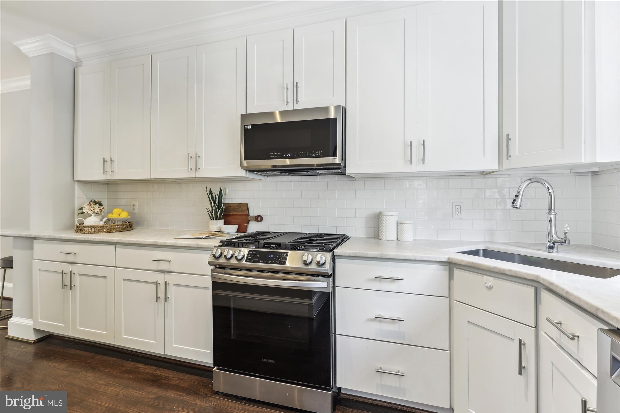 1406 Foxhall Road Northwest Washington, DC 20007 - Photo 10 of 41 a kitchen with white cabinets and stainless steel appliances