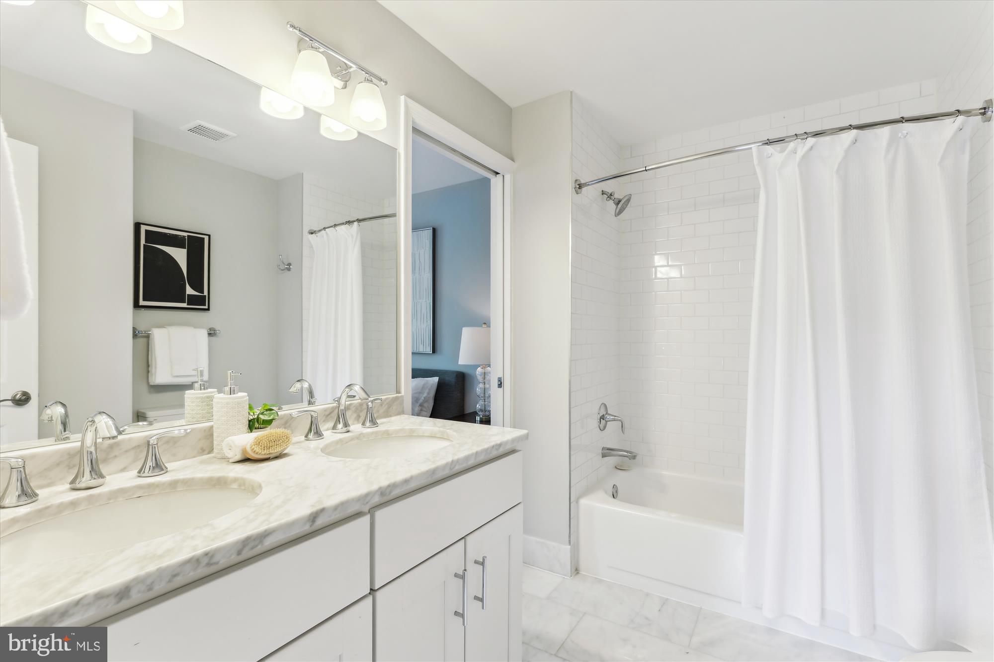 1406 Foxhall Road Northwest Washington, DC 20007 - Photo 14 of 41 a bathroom with a granite countertop sink mirror and a bathtub