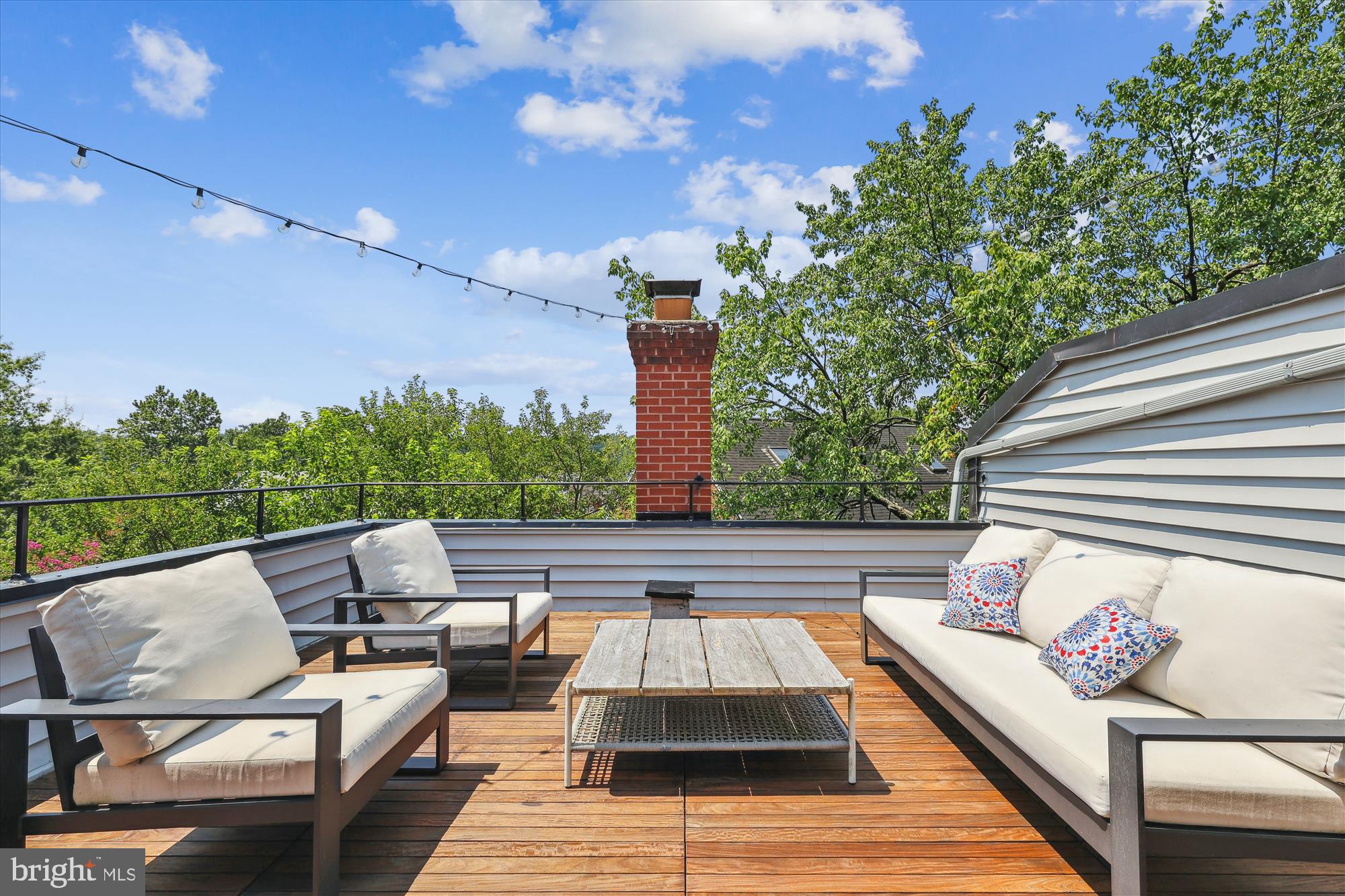 1406 Foxhall Road Northwest Washington, DC 20007 - Photo 20 of 41 a roof deck with table and chairs and potted plants