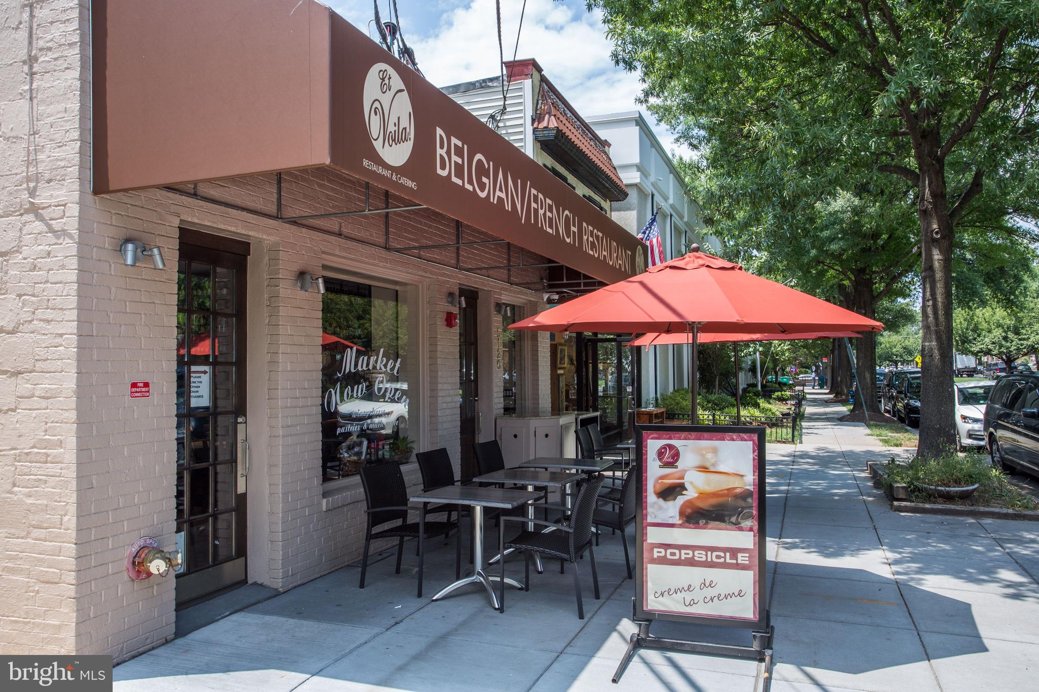 1406 Foxhall Road Northwest Washington, DC 20007 - Photo 34 of 41 a patio with a table and chairs under an umbrella