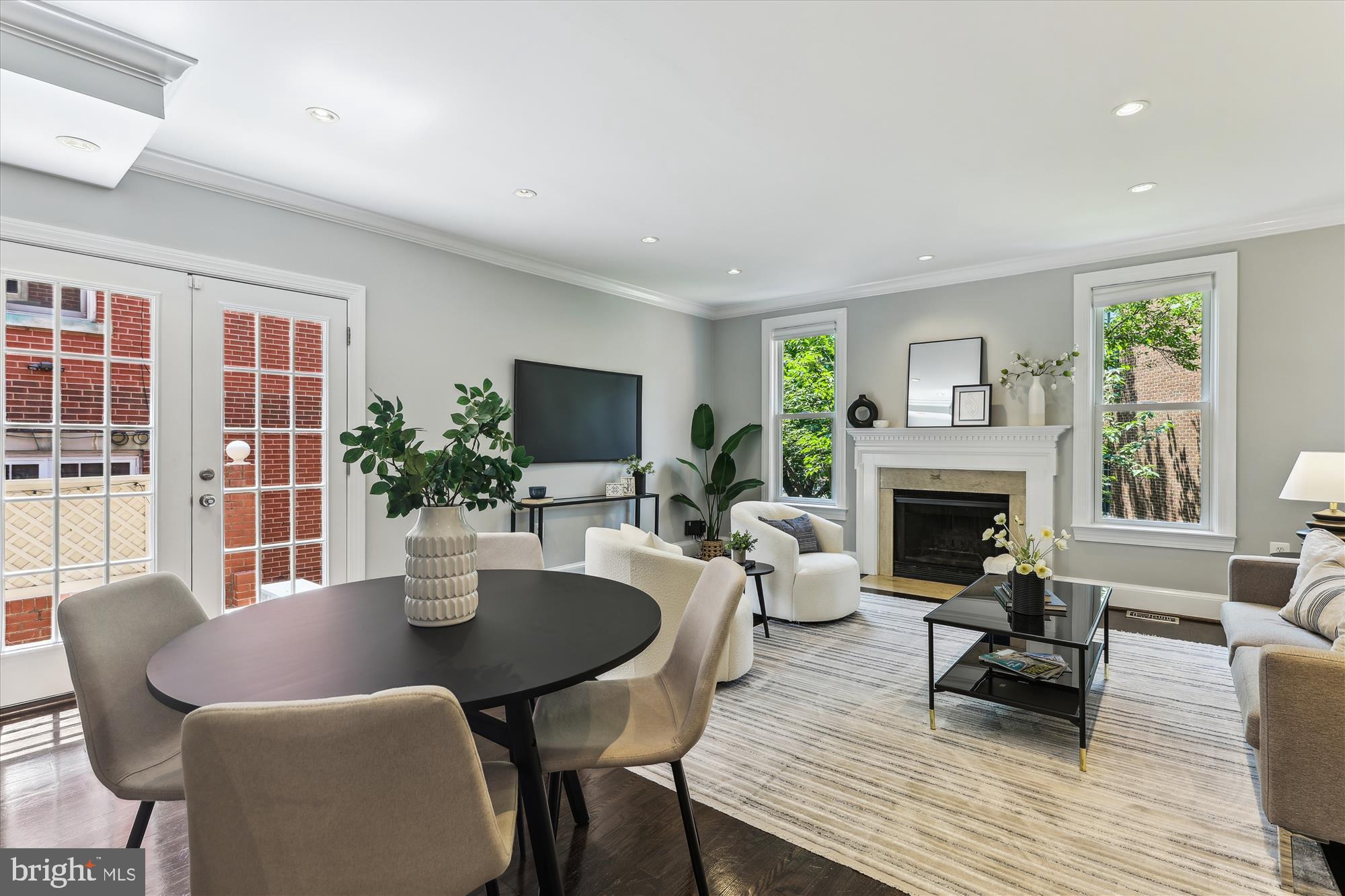 1406 Foxhall Road Northwest Washington, DC 20007 - Photo 7 of 41 a living room with furniture a fireplace and a flat screen tv