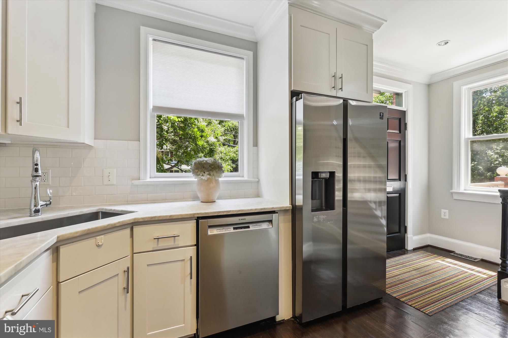 1406 Foxhall Road Northwest Washington, DC 20007 - Photo 8 of 41 a kitchen with stainless steel appliances a refrigerator sink and cabinets