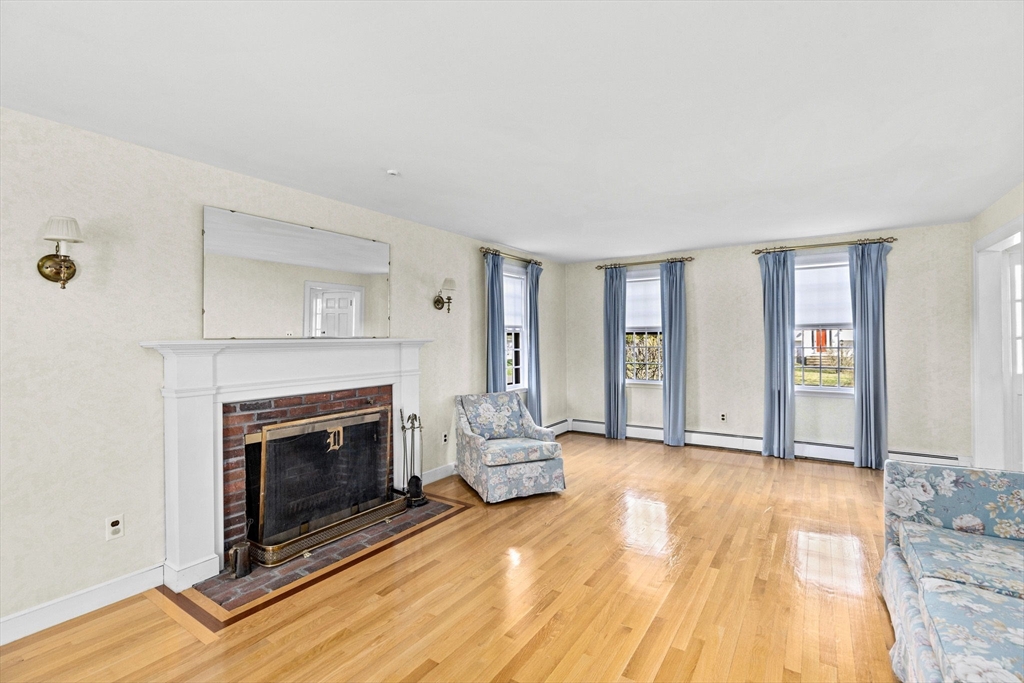 12 Pine Grove Road Hingham, MA 02043 - Photo 13 of 32 a view of a livingroom with wooden floor and a fireplace