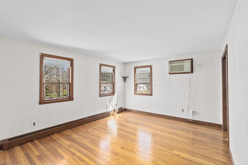 12 Pine Grove Road Hingham, MA 02043 - Photo 17 of 32 a view of an empty room with wooden floor and a window