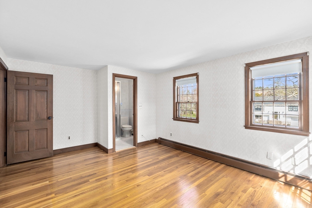 12 Pine Grove Road Hingham, MA 02043 - Photo 18 of 32 a view of an empty room with wooden floor and a window