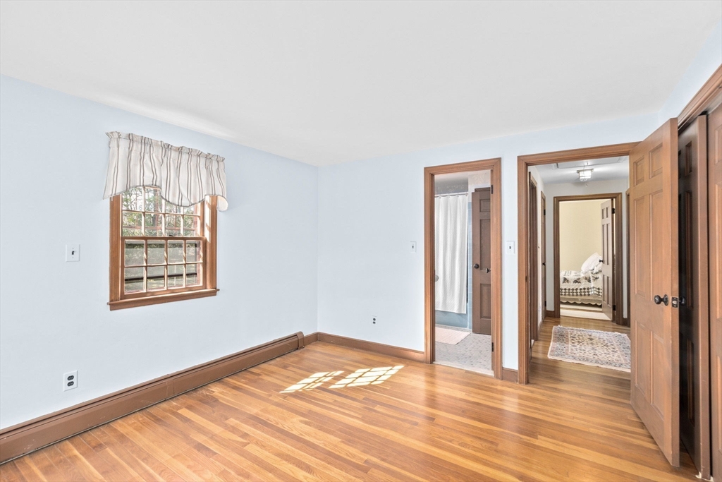 12 Pine Grove Road Hingham, MA 02043 - Photo 19 of 32 a view of an empty room with wooden floor and a window