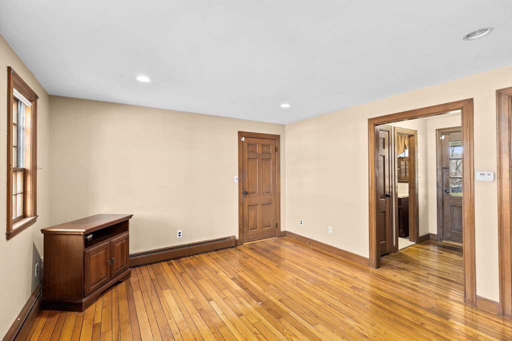 12 Pine Grove Road Hingham, MA 02043 - Photo 2 of 32 an empty room with wooden floor and windows