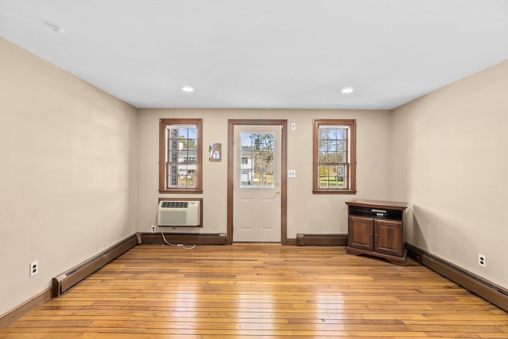 12 Pine Grove Road Hingham, MA 02043 - Photo 3 of 32 a view of an empty room with wooden floor and a window