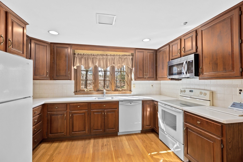 12 Pine Grove Road Hingham, MA 02043 - Photo 4 of 32 a kitchen with a sink stove and refrigerator
