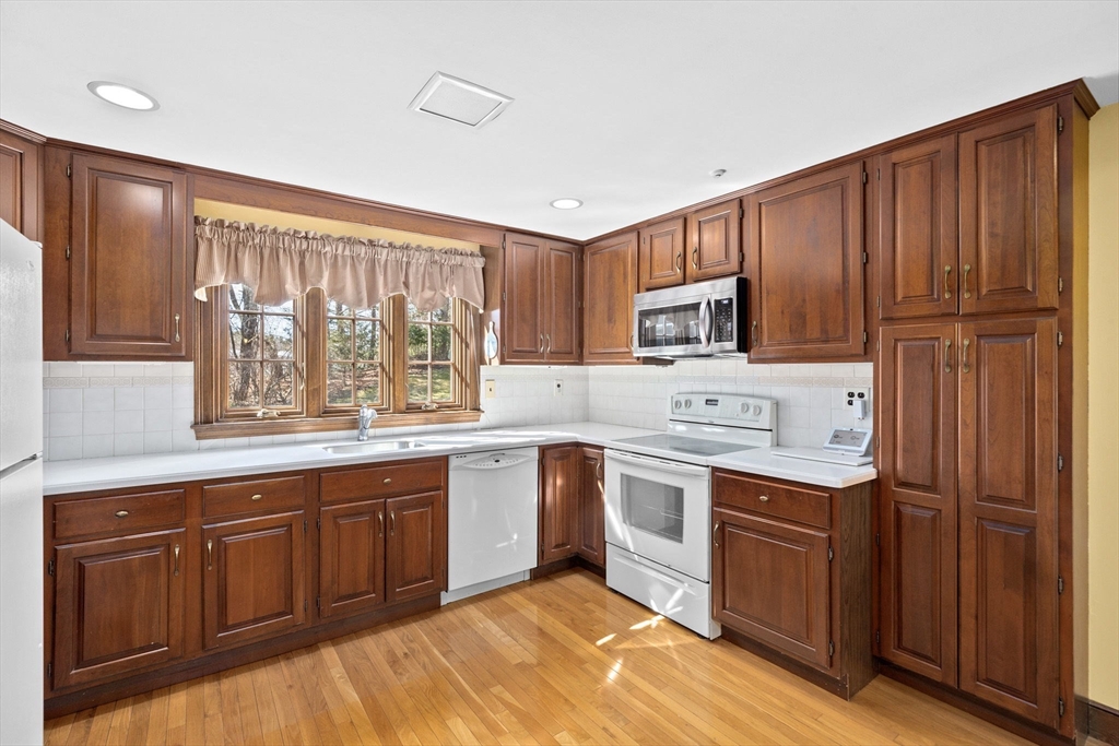 12 Pine Grove Road Hingham, MA 02043 - Photo 5 of 32 a kitchen with stainless steel appliances granite countertop wooden cabinets a sink and dishwasher a oven with wooden floor