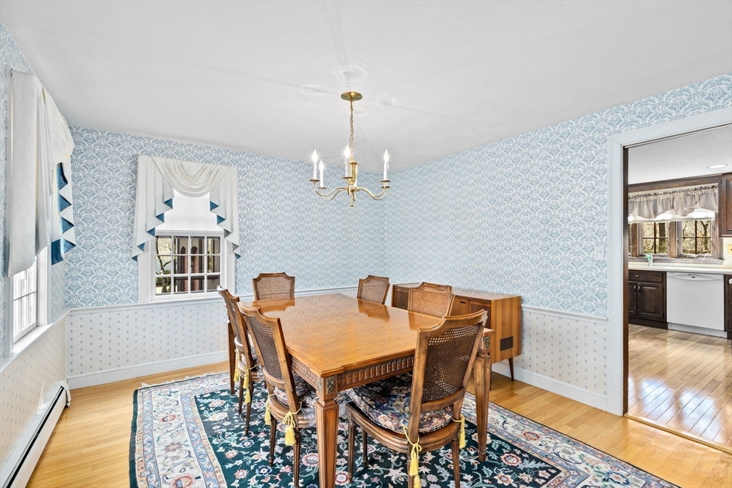 12 Pine Grove Road Hingham, MA 02043 - Photo 7 of 32 a dining room with furniture a rug and a chandelier