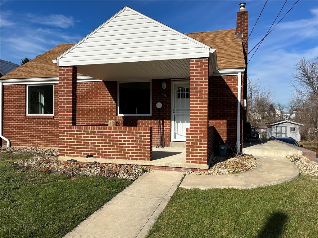 a front view of a house with a garden