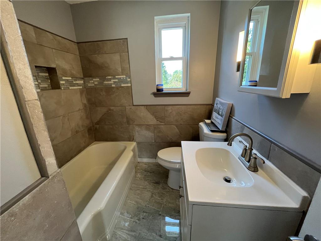 500 Scene Ridge Road McKeesport, PA 15133 - Photo 11 of 26 a bathroom with a sink and mirror with bathtub