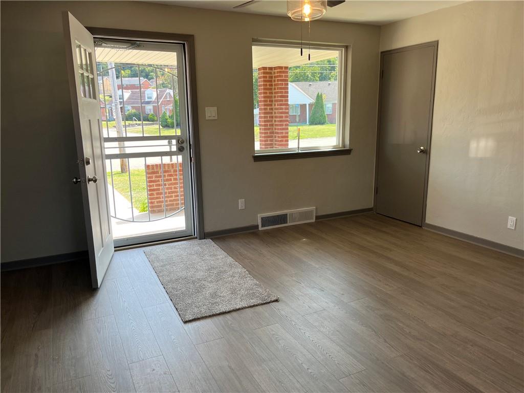 500 Scene Ridge Road McKeesport, PA 15133 - Photo 4 of 26 an empty room with wooden floor and windows
