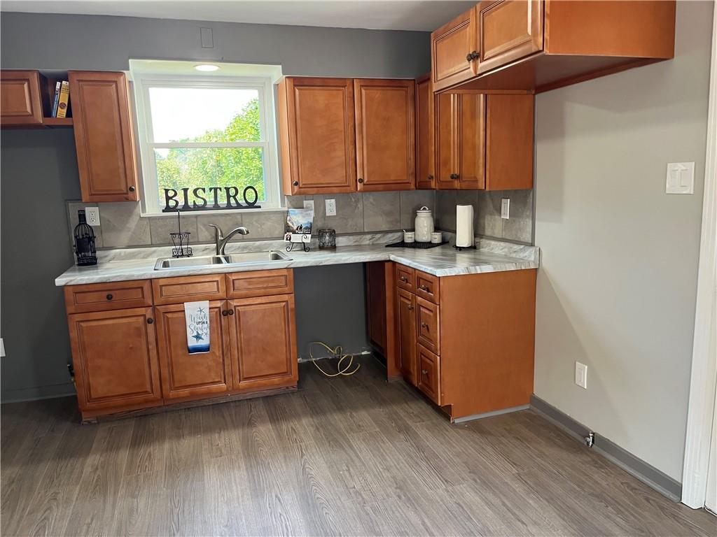 500 Scene Ridge Road McKeesport, PA 15133 - Photo 8 of 26 a kitchen with a sink stove and cabinets