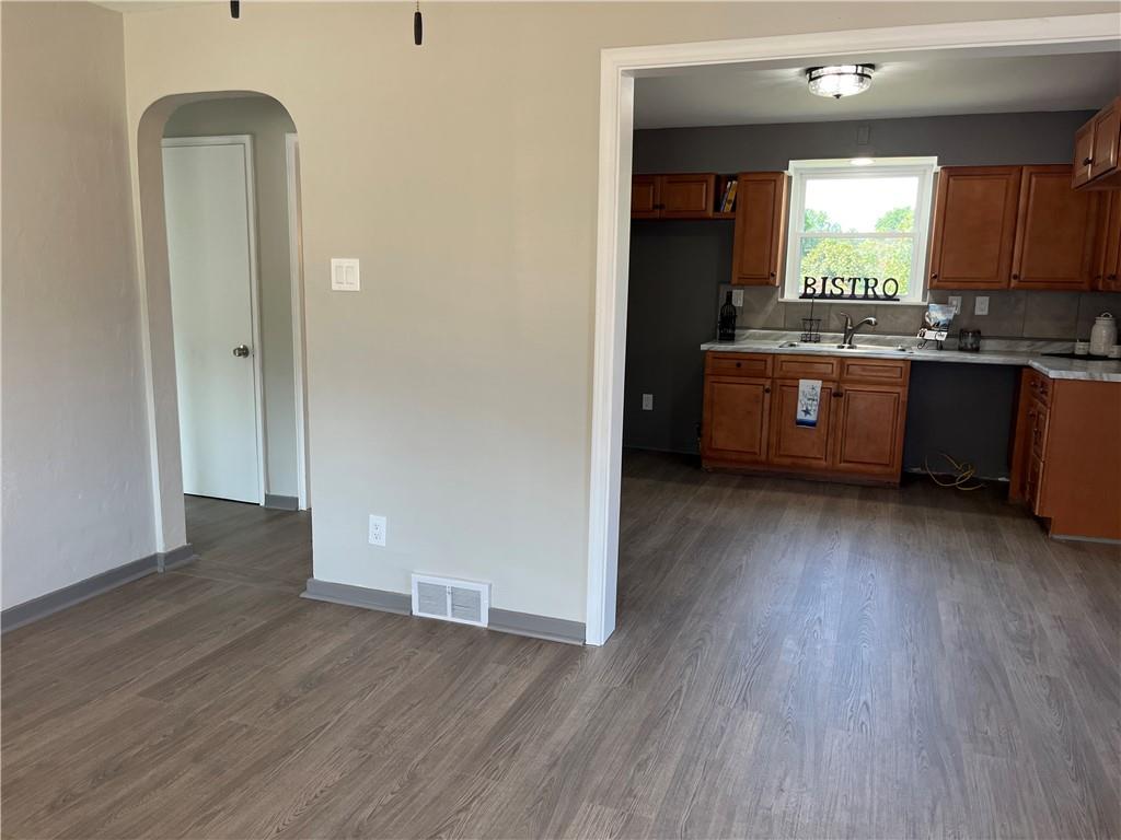 500 Scene Ridge Road McKeesport, PA 15133 - Photo 9 of 26 a kitchen with kitchen island wooden floors and wooden cabinets