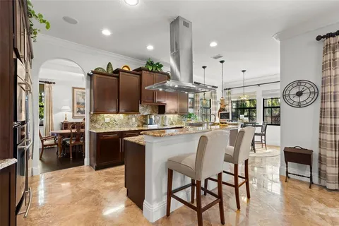 a large kitchen with a table and chairs