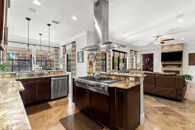 a kitchen with stainless steel appliances granite countertop a stove refrigerator and microwave