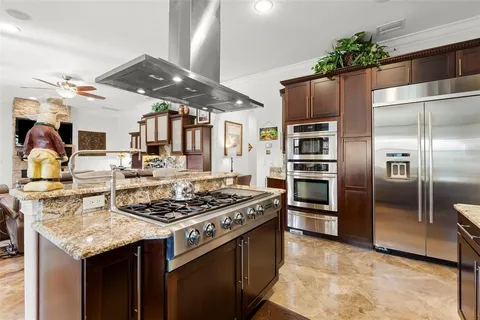 a stove top oven sitting inside of a kitchen