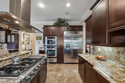 a kitchen with a sink and a wooden floor