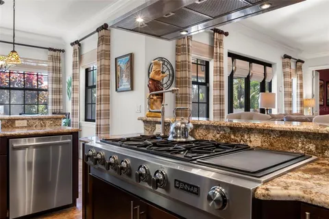 a view of a dining room with furniture large windows and wooden floor