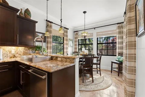 a living room with stainless steel appliances kitchen island granite countertop furniture and a kitchen view