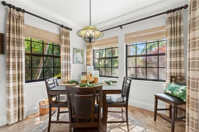 a living room with furniture kitchen view and a large window