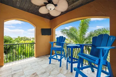 a view of a chairs and table in the balcony