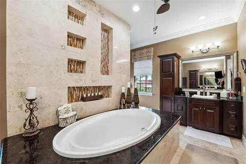 a living room with furniture a flat screen tv and a floor to ceiling window