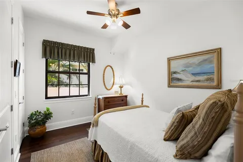 a bathroom with a granite countertop sink vanity mirror and toilet