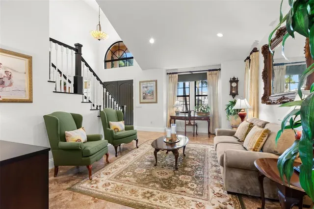 a living room with fireplace furniture and a rug