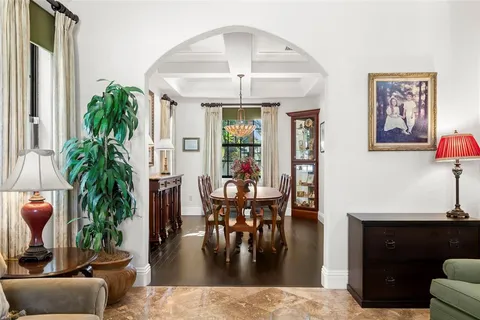a view of a dining room with furniture and a chandelier