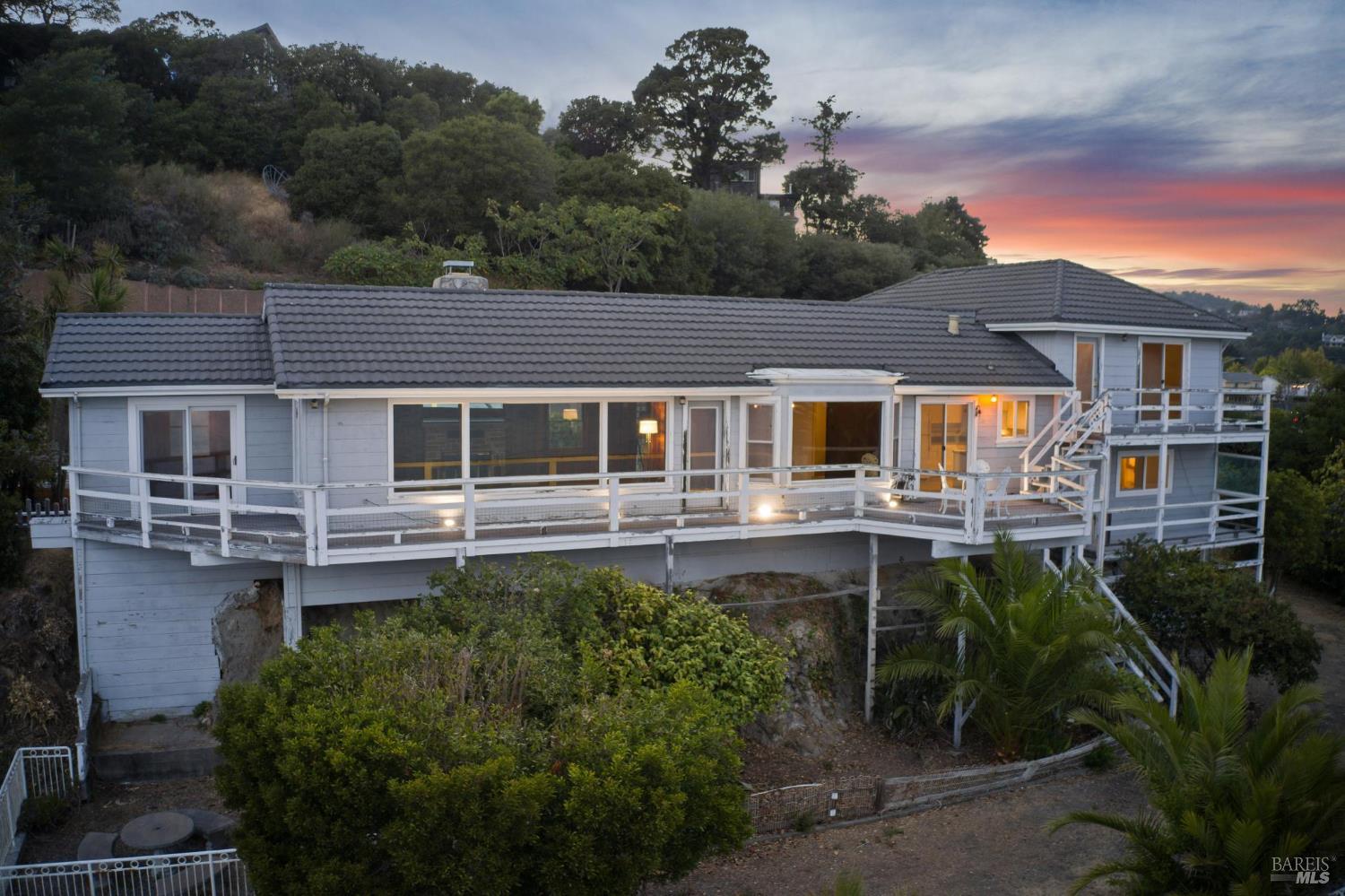 836 Point San Pedro Road San Rafael, CA 94901 - Photo 19 of 83 a front view of a house with a yard table and chairs