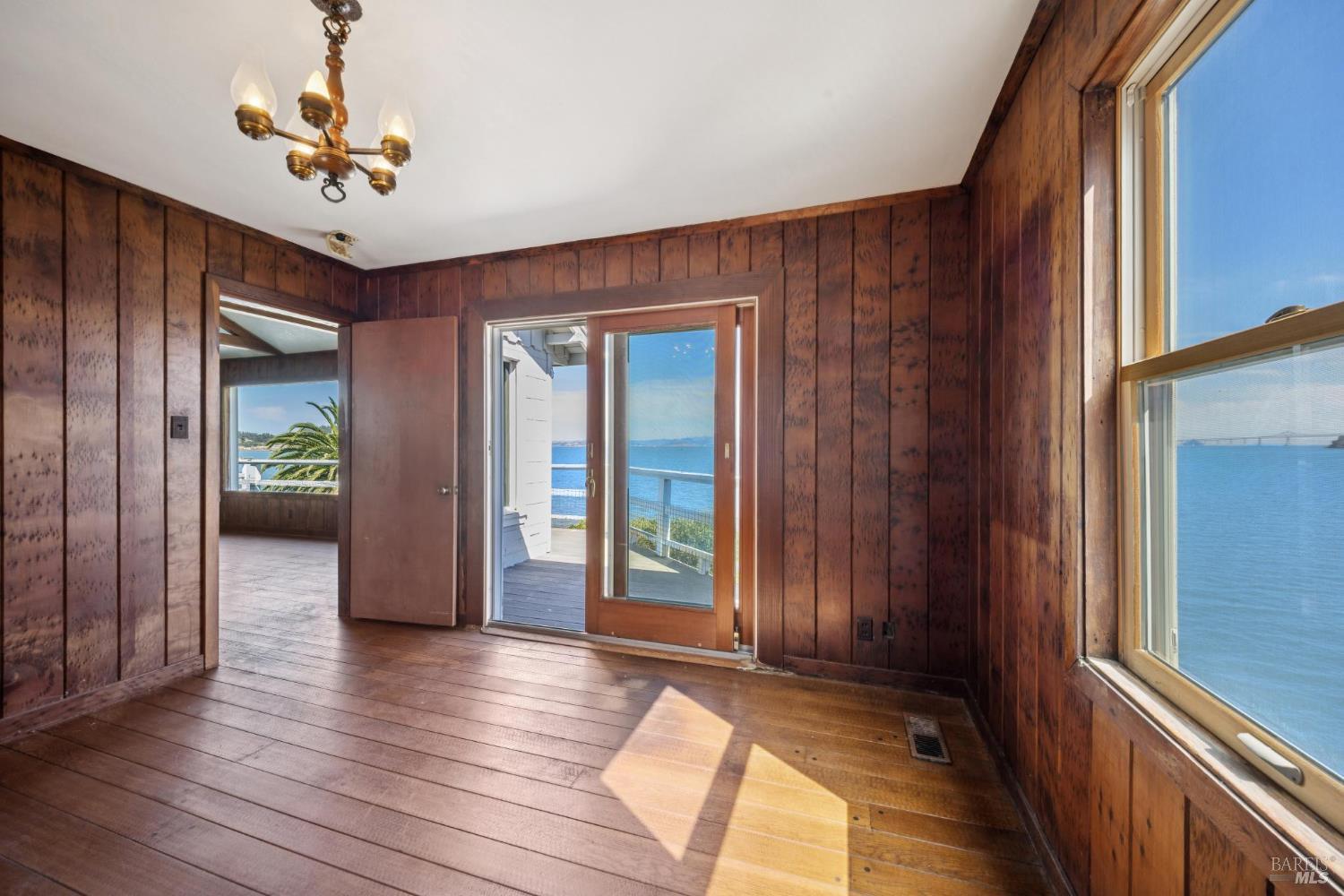 836 Point San Pedro Road San Rafael, CA 94901 - Photo 34 of 83 a view of a hallway with wooden floor and a chandelier