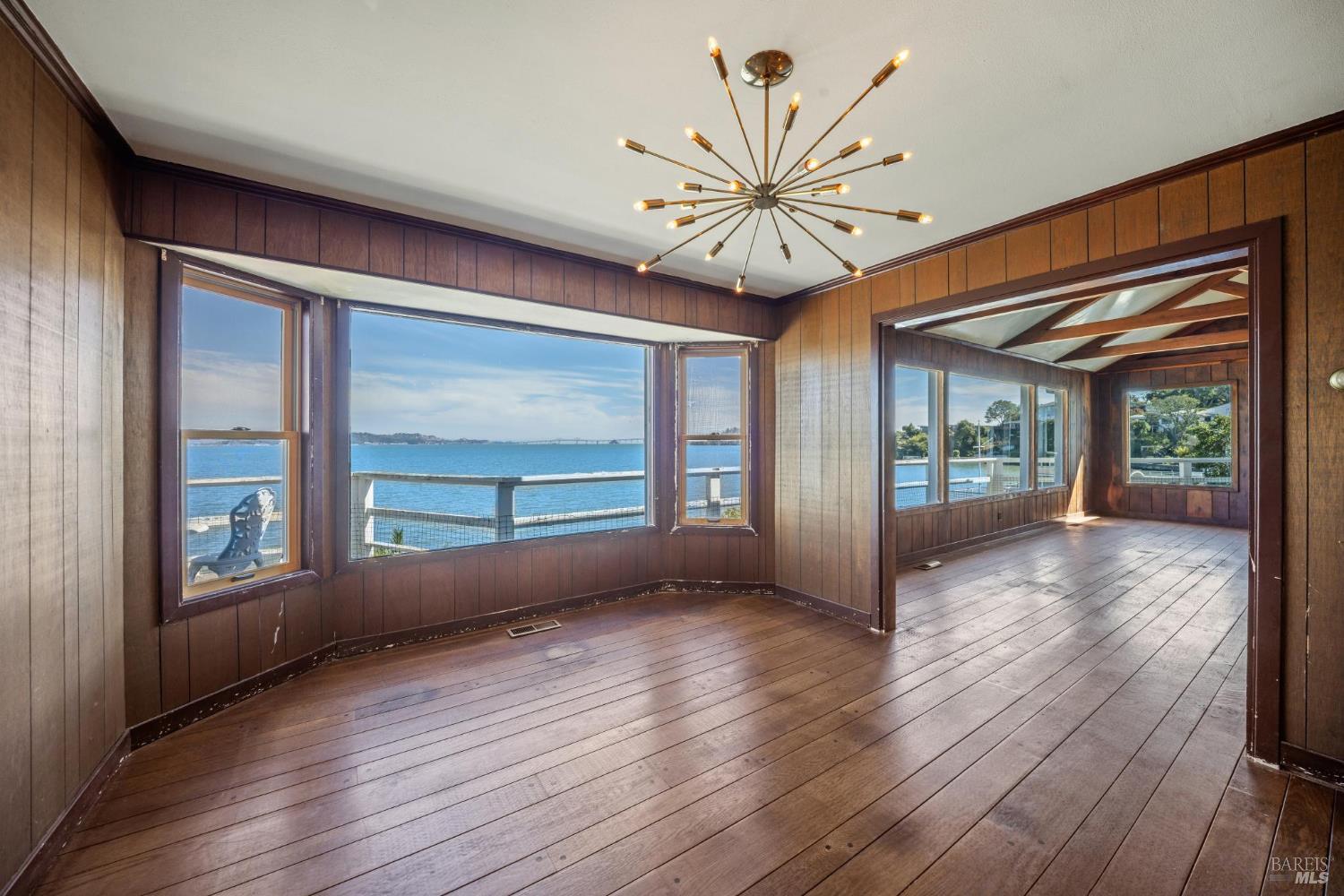 836 Point San Pedro Road San Rafael, CA 94901 - Photo 35 of 83 a view of an empty room with wooden floor and a window