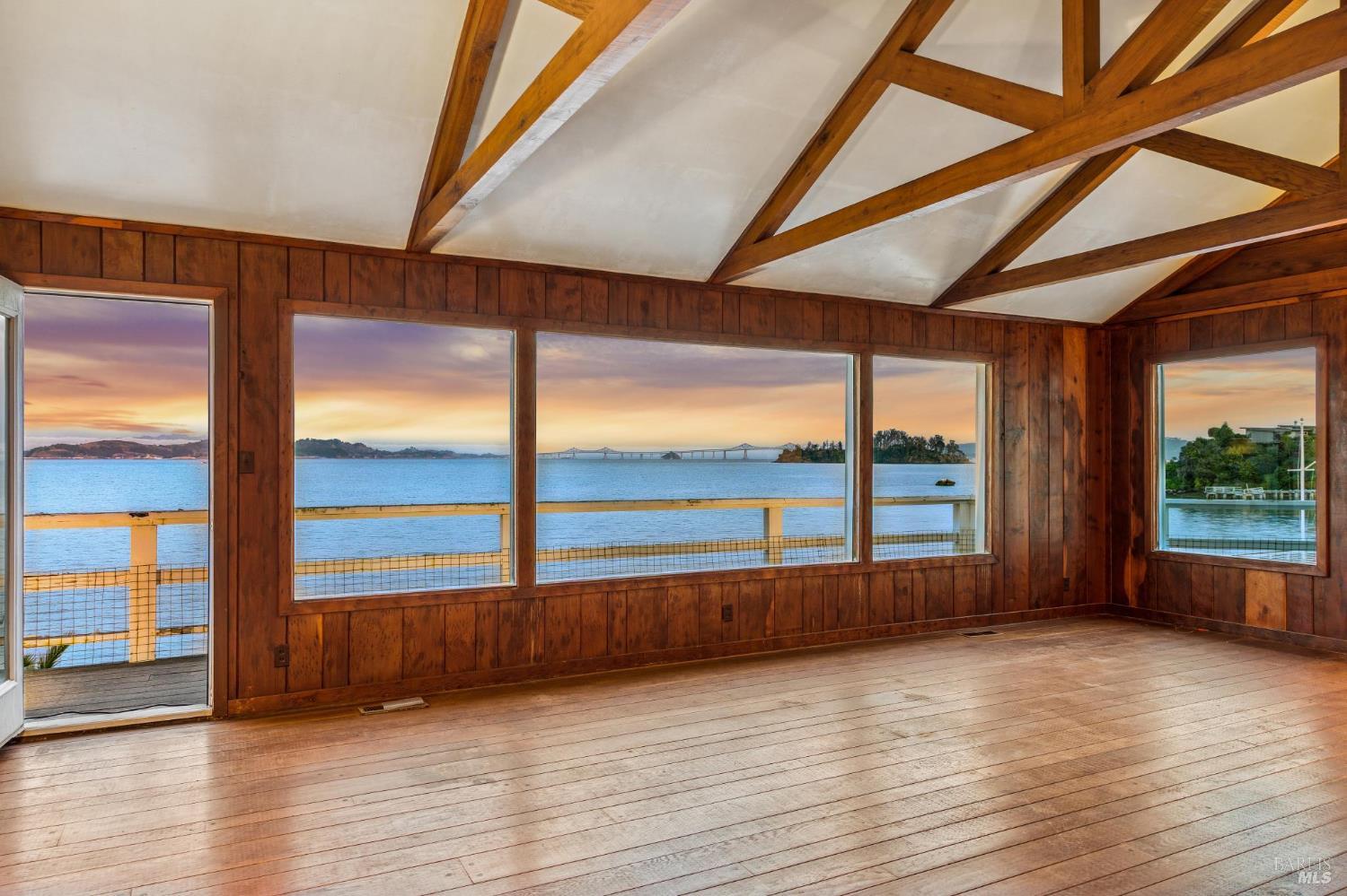836 Point San Pedro Road San Rafael, CA 94901 - Photo 4 of 83 a view of an empty room with wooden floor and a window