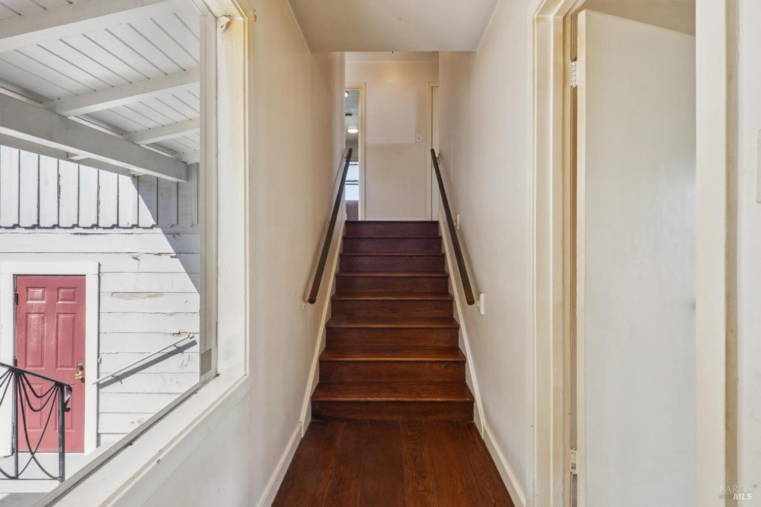 836 Point San Pedro Road San Rafael, CA 94901 - Photo 43 of 83 a view of a hallway with wooden floor and staircase