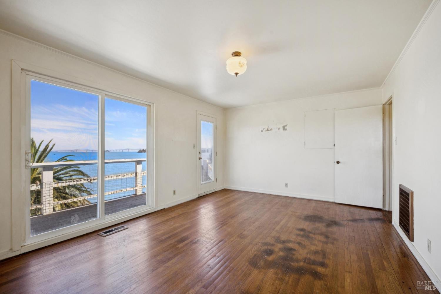 836 Point San Pedro Road San Rafael, CA 94901 - Photo 45 of 83 an empty room with wooden floor and window