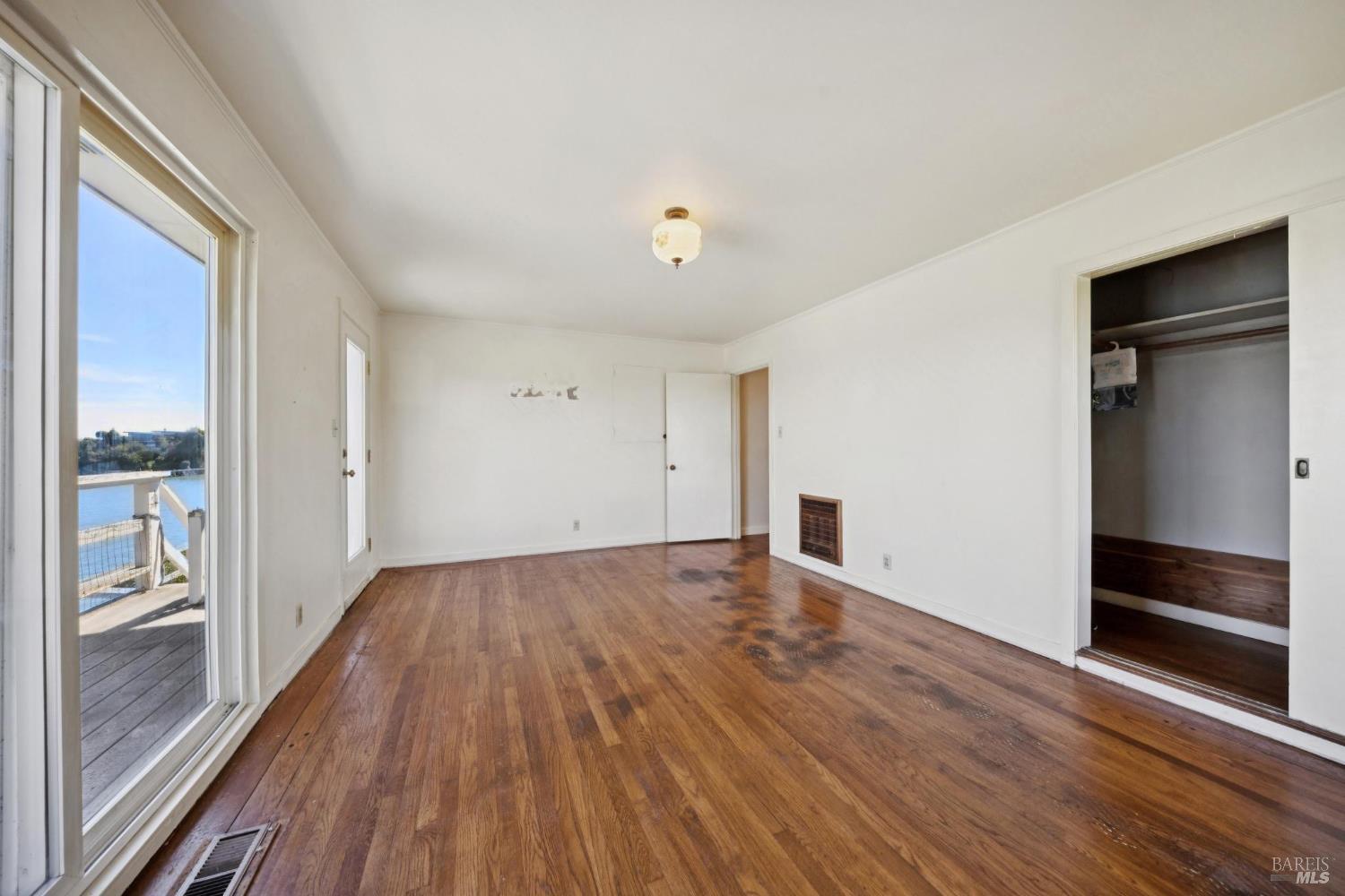 836 Point San Pedro Road San Rafael, CA 94901 - Photo 46 of 83 wooden floor in an empty room with a window