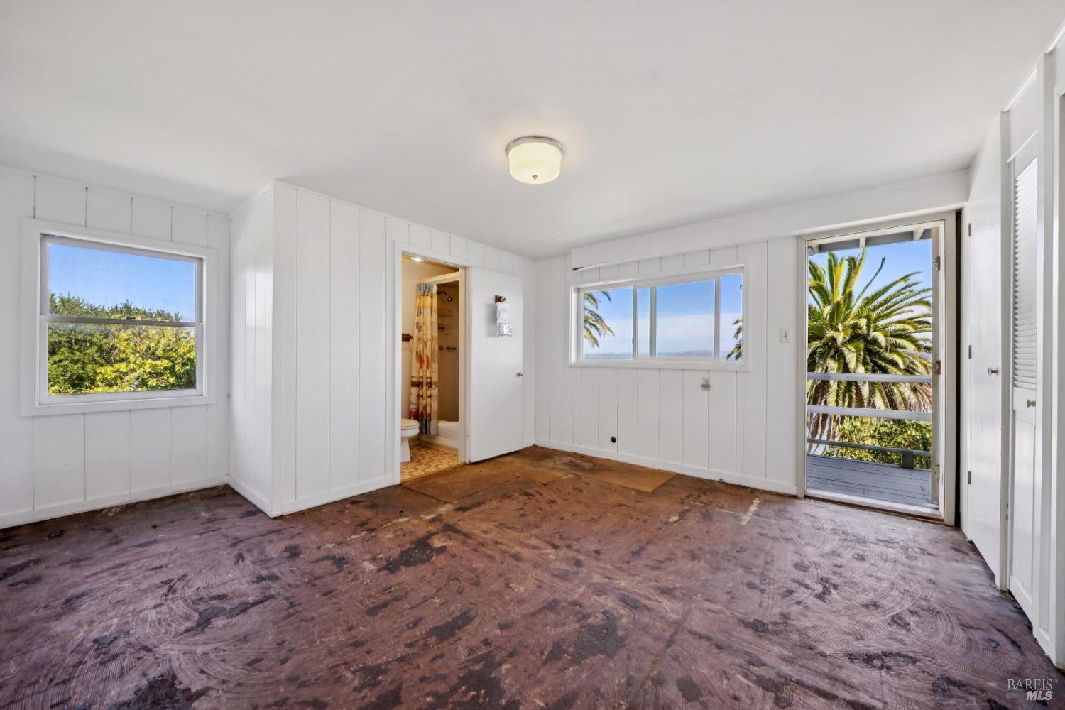 836 Point San Pedro Road San Rafael, CA 94901 - Photo 56 of 83 a view of an empty room with window and wooden floor