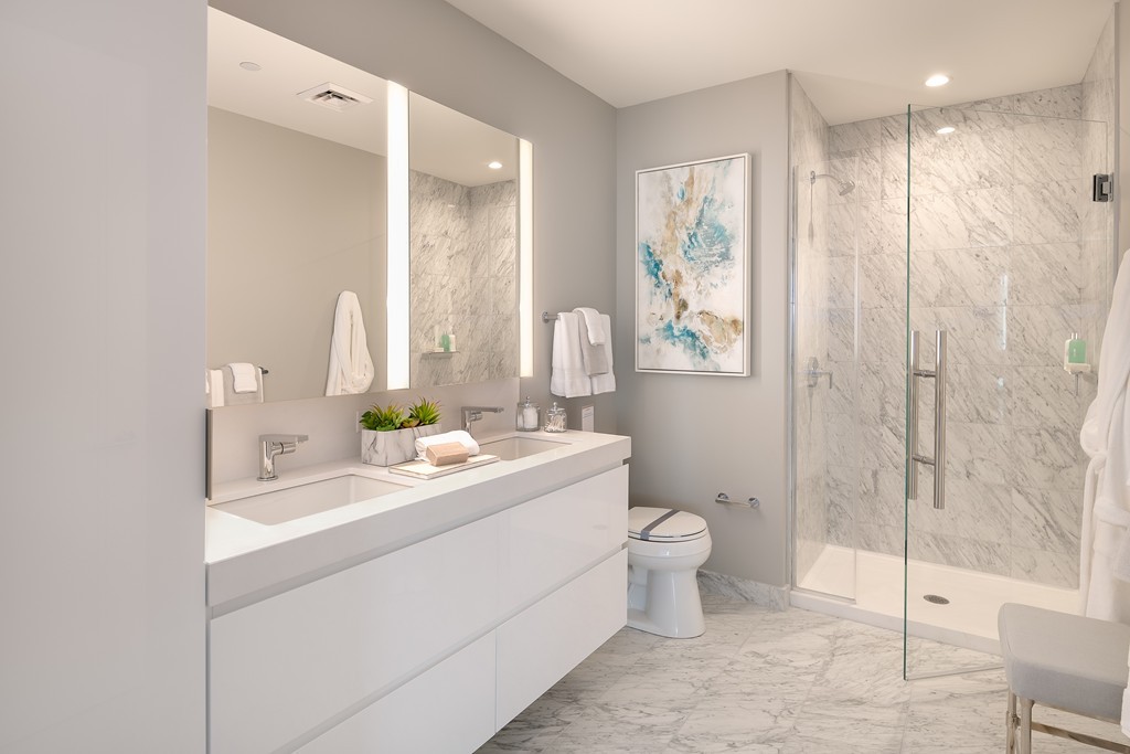 133 Seaport Boulevard, Unit 1017 Boston, MA 02210 - Photo 7 of 17 a bathroom with a double vanity sink toilet and shower